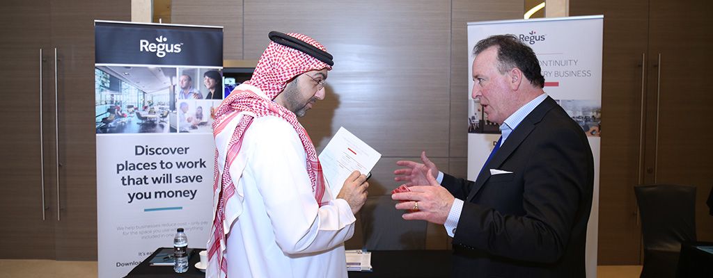 Two men are stood having a discussion at the Regus 8th Middle East Business & IT Resilience Summit in Dubai